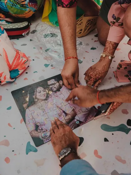 Guests work together to complete a puzzle of the couple's photo. These shared activities create a sense of community and fun among all who attend.