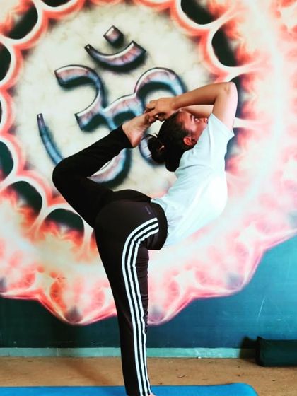 This is an advanced variation of Natarajasana, or Lord of the Dance Pose. I am holding this posture in front of a beautiful Om mandala, reminding me that yoga is a journey of moving the joints every day.