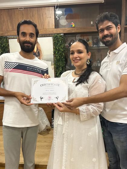 A student from the runner-up team receives his certificate. The smiles and handshakes show the mutual respect and friendship in our community.