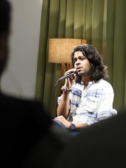 A singer's soulful performance, seen from the perspective of an audience member.