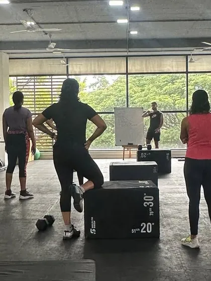 A snapshot from one of our group classes. Here, I am explaining the workout of the day (WOD) before we get started. Everyone is focused and ready to tackle the challenge together.
