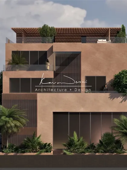 This view highlights the home's layered design. The recessed balconies provide privacy and shade, while the rooftop pergola adds a light, structural element to the solid form of the building.