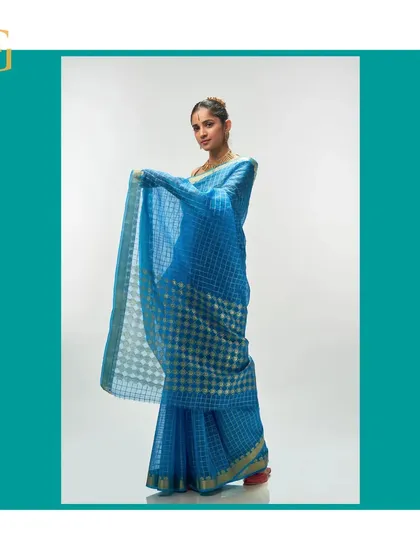 Another look at the Persian blue organza saree in motion, emphasizing its airy and graceful quality.