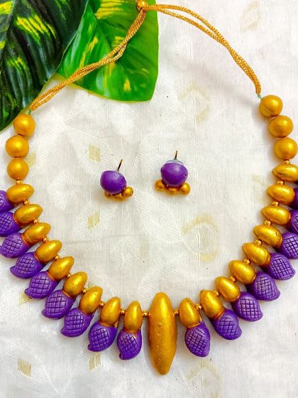 The same leaf-textured choker design, here in a beautiful purple and gold combination.