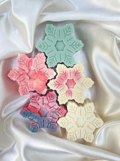 A collection of my snowflake soaps. Each one has a unique color swirl, making them a beautiful and delicate set.