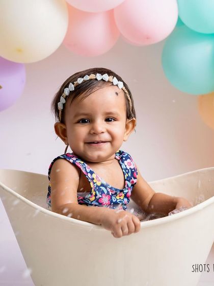 A sweet, bubbly smile from the tub. This is the perfect way to end a first birthday photoshoot, with a clean and happy baby.