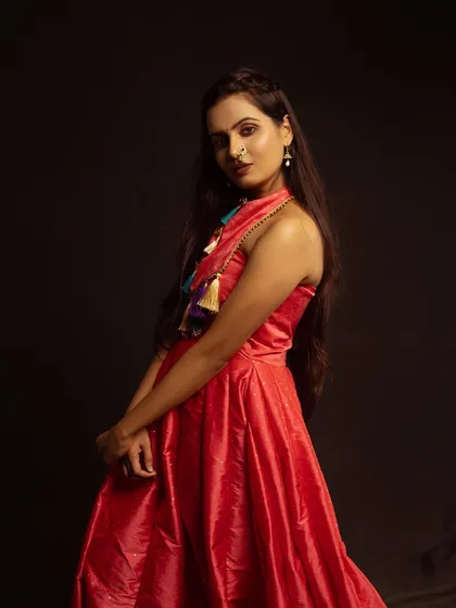A three-quarter profile shot, showing the flow of the dress and the model's elegant posture.
