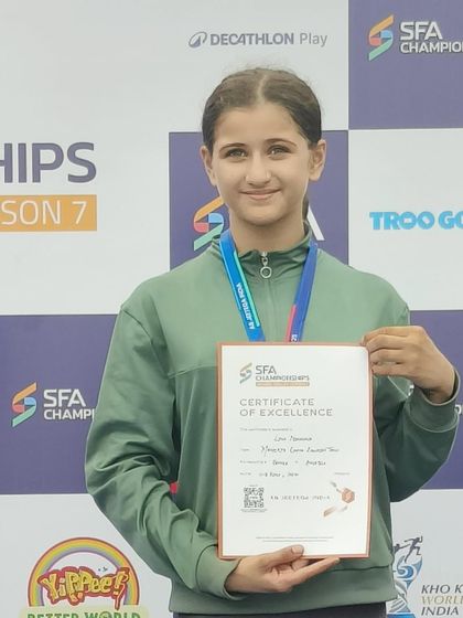 Linn proudly displays her Certificate of Excellence from the SFA Championship, a mark of her outstanding performance.