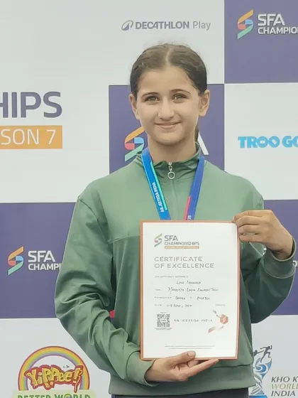 Linn proudly displays her Certificate of Excellence from the SFA Championship, a mark of her outstanding performance.