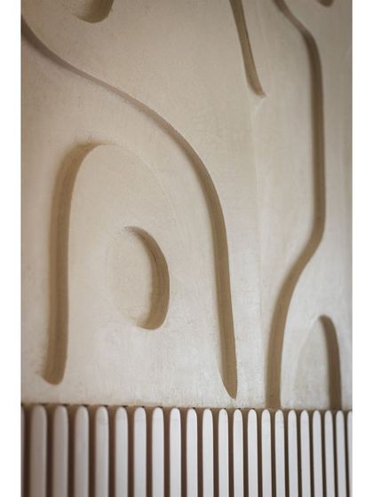Another detail of the custom wall relief, showcasing the craftsmanship and attention to detail that went into creating this unique feature.