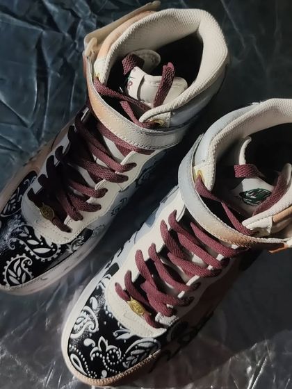 A top-down view of the Tupac custom AF1 Mids. The contrast between the bandana print and the portraits is really cool.