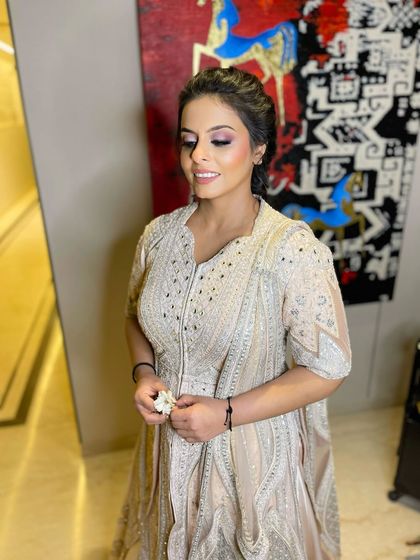 The soft smokey eye and glowing skin create a look of pure elegance.