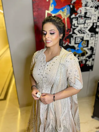 A candid, happy moment. Her radiant skin and perfectly applied makeup look fresh and flawless even in a relaxed pose.