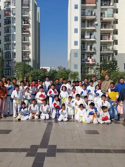 An outdoor belt grading event. We take pride in our students' progress and celebrate their achievements as a community.