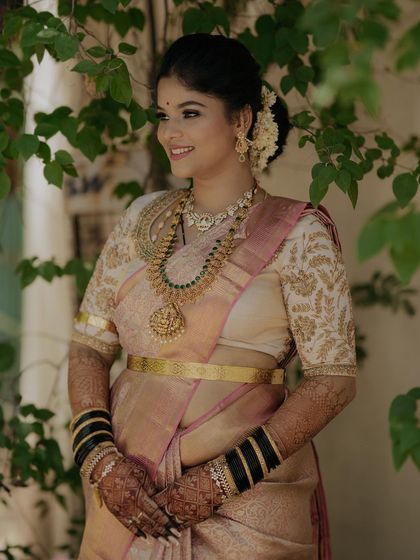 Another shot of Gagana's reception look, set against a natural backdrop. The makeup looks fresh and elegant.