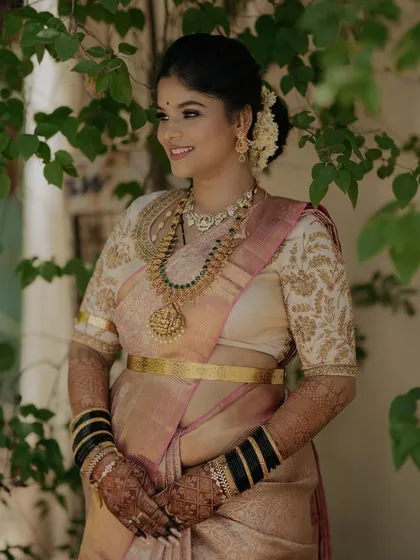 Another shot of Gagana's reception look, set against a natural backdrop. The makeup looks fresh and elegant.
