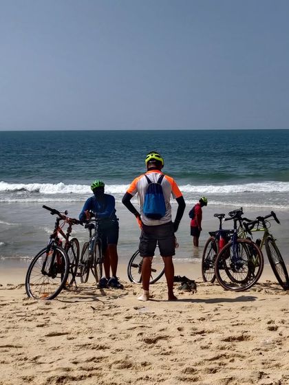 A group of riders and their bikes right on the sand, with the waves of the Arabian Sea just feet away. This is what beach riding is all about.