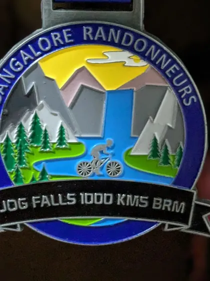 A close-up of the coveted Jog Falls 1000K BRM medal. This is the tangible reward for pushing through 75 hours of grueling terrain and weather.