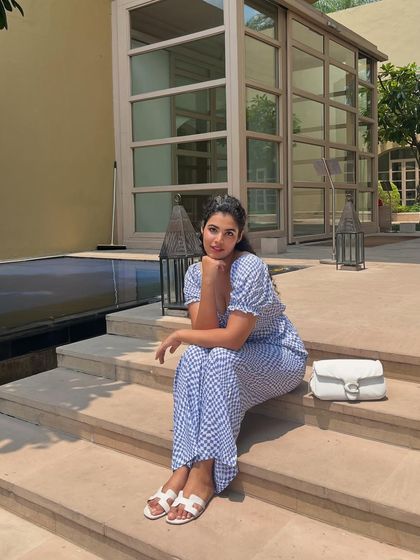 Rains for a night and I start longing for summers. A photo of me in a blue gingham jumpsuit, sitting by a pool, dreaming of sunny days.