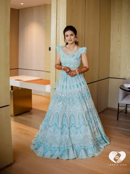 A full portrait of the bride in her fairytale gown. The makeup is kept soft and elegant to complement the stunning outfit.