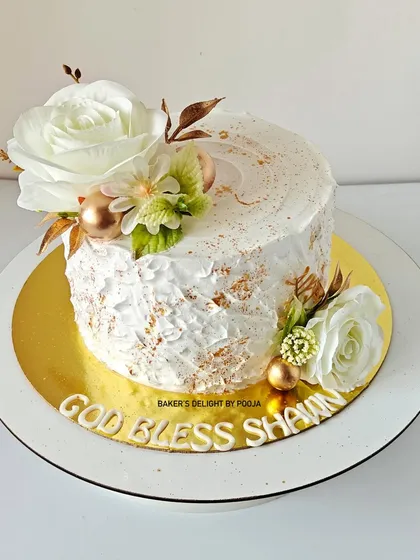 This textured white cake with white florals and golden accents was made to honor Shawn's Confirmation. It's a simple, elegant design for a moment of spiritual growth.