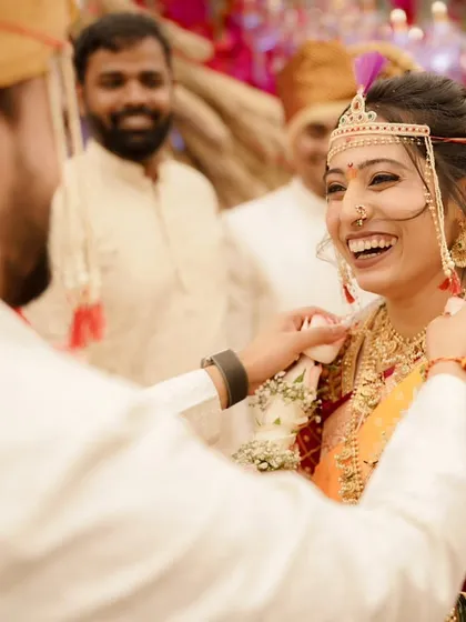 A moment of pure, uninhibited laughter. The bride's face is lit up with joy, and her radiant makeup only enhances her natural glow.
