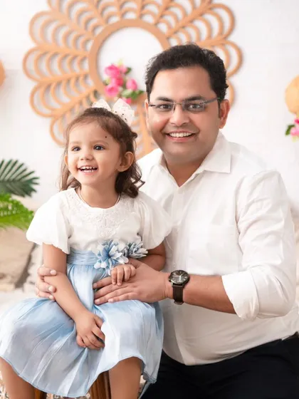A proud father and his daughter. This classic portrait captures a beautiful, happy moment between them in our bright and airy boho setup.