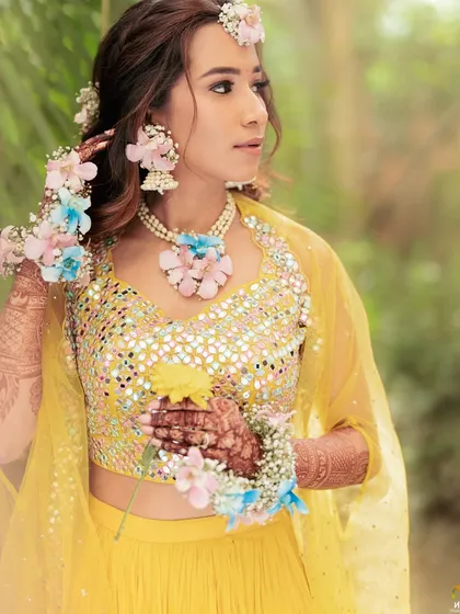 A side profile showing the details of the floral necklace and earrings. We work closely with our clients to match the jewellery to their outfit and personal style.