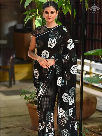 For a modern and chic look, I love the effortless grace of georgette. This black saree with a bold white and blue rose print is lightweight and flows beautifully. It’s a versatile piece that is perfect for evening parties, dinners, or any event where you want to look sophisticated.
