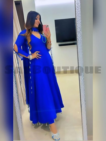 A full-length mirror selfie of the client in her beautiful royal blue Anarkali.