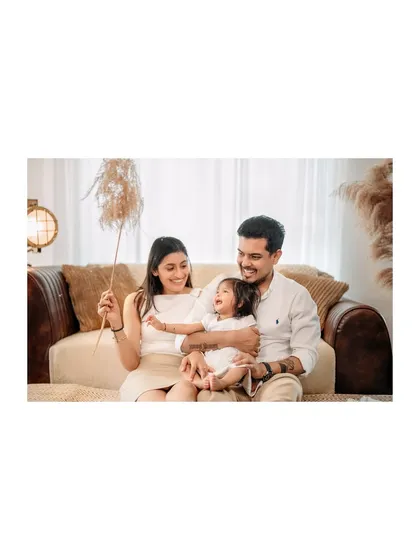 A playful moment with a stalk of pampas grass brings out a huge laugh from their daughter. I love using simple props to encourage natural, happy interactions.