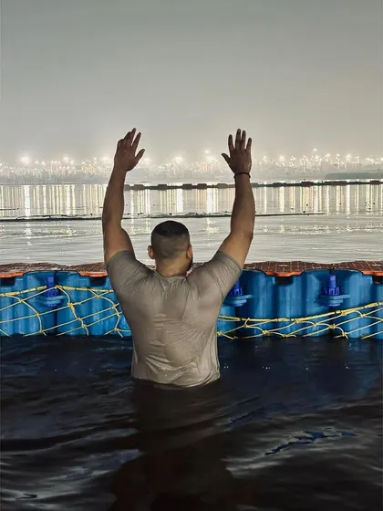 Arms raised in prayer during the Mahakumbh. Moments like these provide a deep sense of peace and purpose.