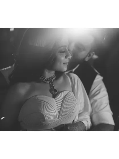 A romantic black and white photo. The focus is on the couple's connection and the beautiful silhouette of the bride's sculpted Amit Aggarwal dress.