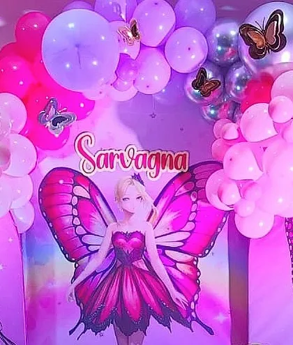A vibrant butterfly fairy theme in shades of pink and purple. The backdrop features a beautiful fairy character, perfect for a magical birthday.