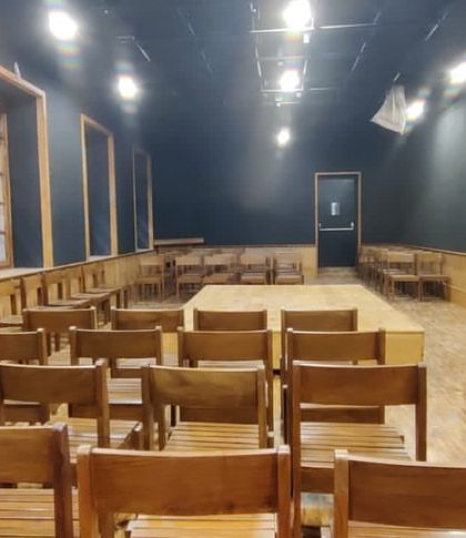 A side view of the seating arrangement in the Black Box Theatre, emphasizing the simple, functional aesthetic that allows the performances to take center stage.