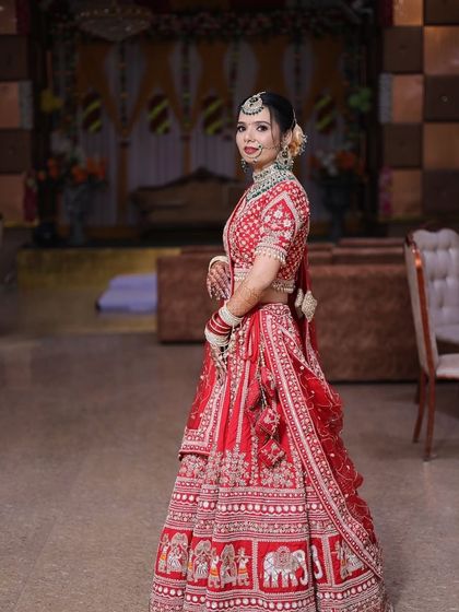 A side profile of the bride, showing how the makeup and hairstyle come together. The neat bun is adorned with flowers, and the HD makeup looks seamless from every angle.