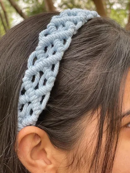 A close-up of our most loved product, the macrame hairband. The intricate knotting creates a beautiful texture. It's available in 12 different colors.