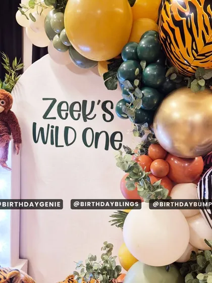 A close-up of the "Wild One" decor, highlighting the custom lettering on the backdrop and the fun monkey prop. The mix of different balloon textures and prints adds visual interest.