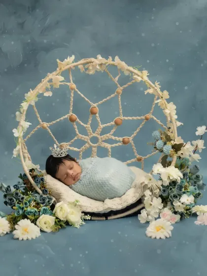 A slightly different angle of this dreamy setup, showing the beautiful details of the dreamcatcher prop and the baby wearing a tiny crown.