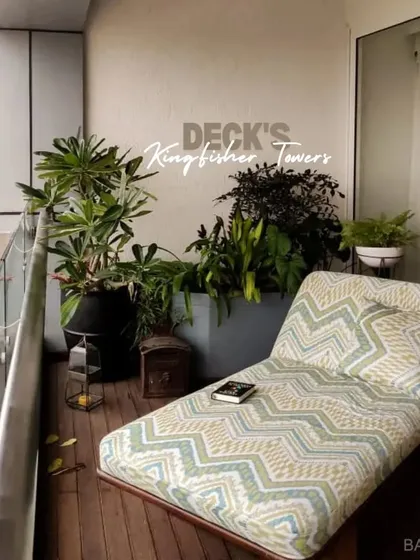 A comfortable chaise lounge on a wooden deck at Kingfisher Towers, creating a perfect spot for outdoor relaxation.