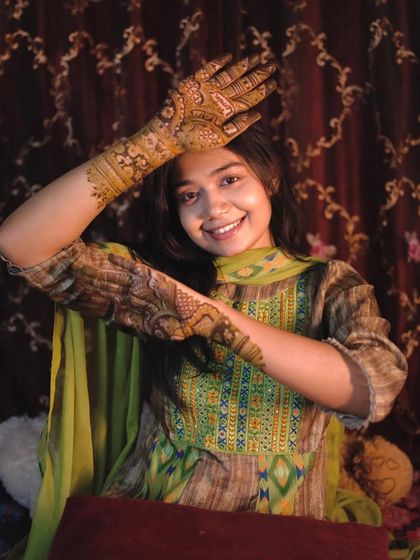 A playful pose from a happy client. Getting mehndi is all about feeling good and celebrating yourself.