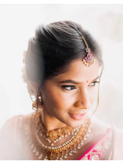 Flawless minimal skin work for Sneha, captured in beautiful sunlight. This bright, airy shot highlights the natural, dewy finish of her makeup.