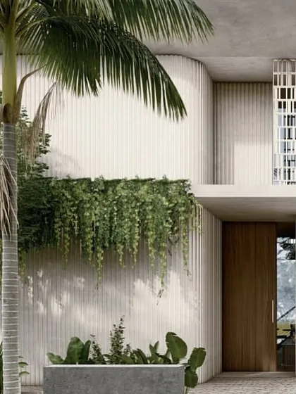 The entrance to one of the pavilion homes, where a solid wood door is set within a composition of textured concrete, hanging planters, and a perforated screen. This moment captures the balance of coolness and warmth, solidity and transparency.