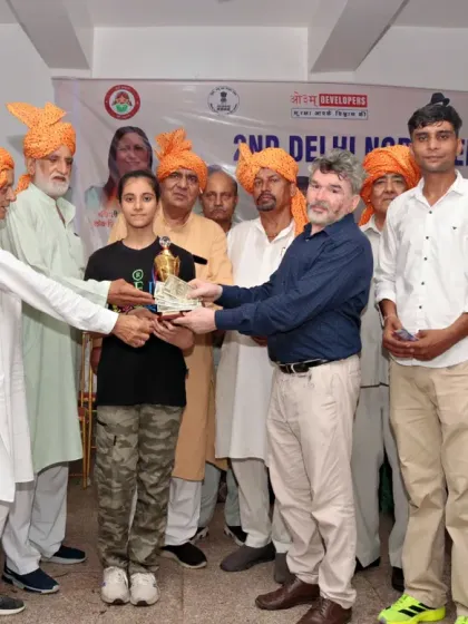 A student receiving a trophy at the 2nd Delhi North Open Karate Championship. We encourage participation in competitive events to test their skills.