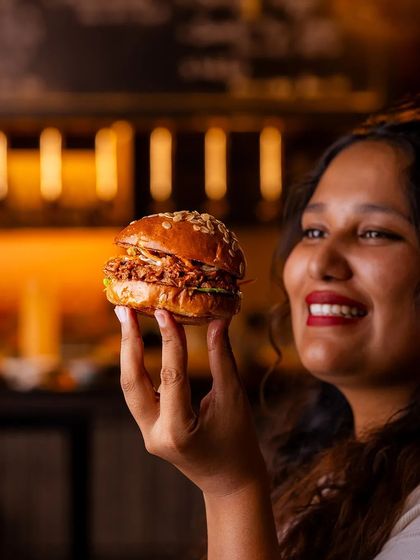 Our Hickory-Smoked Pulled Pork Burger, a taste of a Texan summer weekend with tender pork and tangy barbecue sauce.