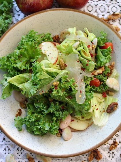 A top-down view of our refreshing Double Beans, Kale & Ice Apple Salad. The leafy kale, crunchy walnuts, and nutritious double beans make it a perfect, light meal.