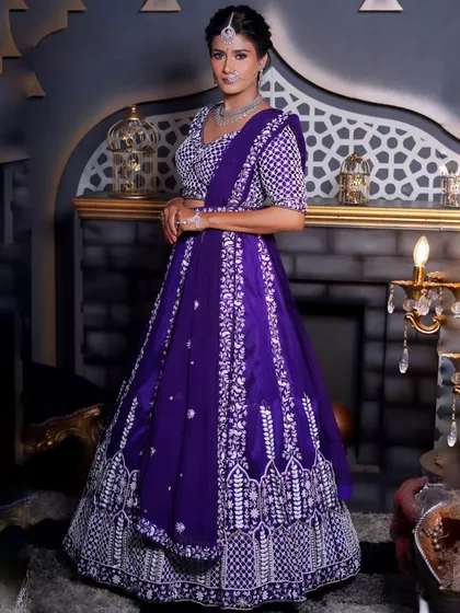 A full-length shot of the purple and white embroidered lehenga in a regal setting. This outfit is perfect for creating dramatic and beautiful photos.