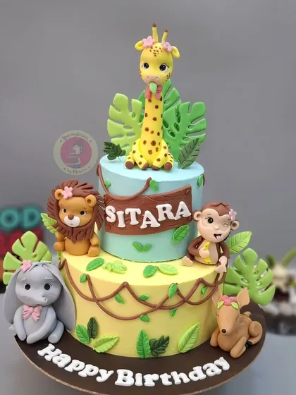 A burst of color and joy with this two-tiered jungle theme cake. Managing multiple, detailed fondant animals and keeping the design clean and vibrant is a key skill. This cake is a perfect example of the complex, multi-element projects we learn to master in my workshops.