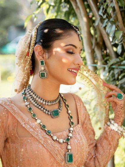 A smiling, candid shot of the model. The makeup enhances her natural beauty, creating a look that is both elegant and approachable.