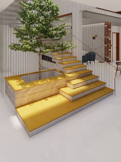 This view shows the relationship between the indoor courtyard, the staircase, and the dining area. The open-plan design and consistent use of materials create a harmonious and flowing space.